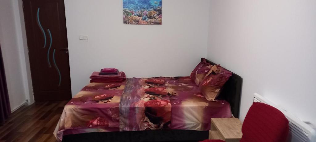 een slaapkamer met een bed met een rood dekbed bij Strada Banu Mihalcea Nr. 150 in Constanţa