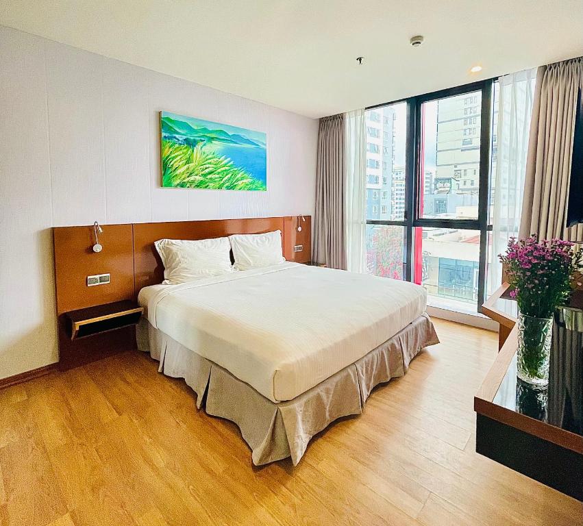 Postel nebo postele na pokoji v ubytování NAM Hotel & Residences