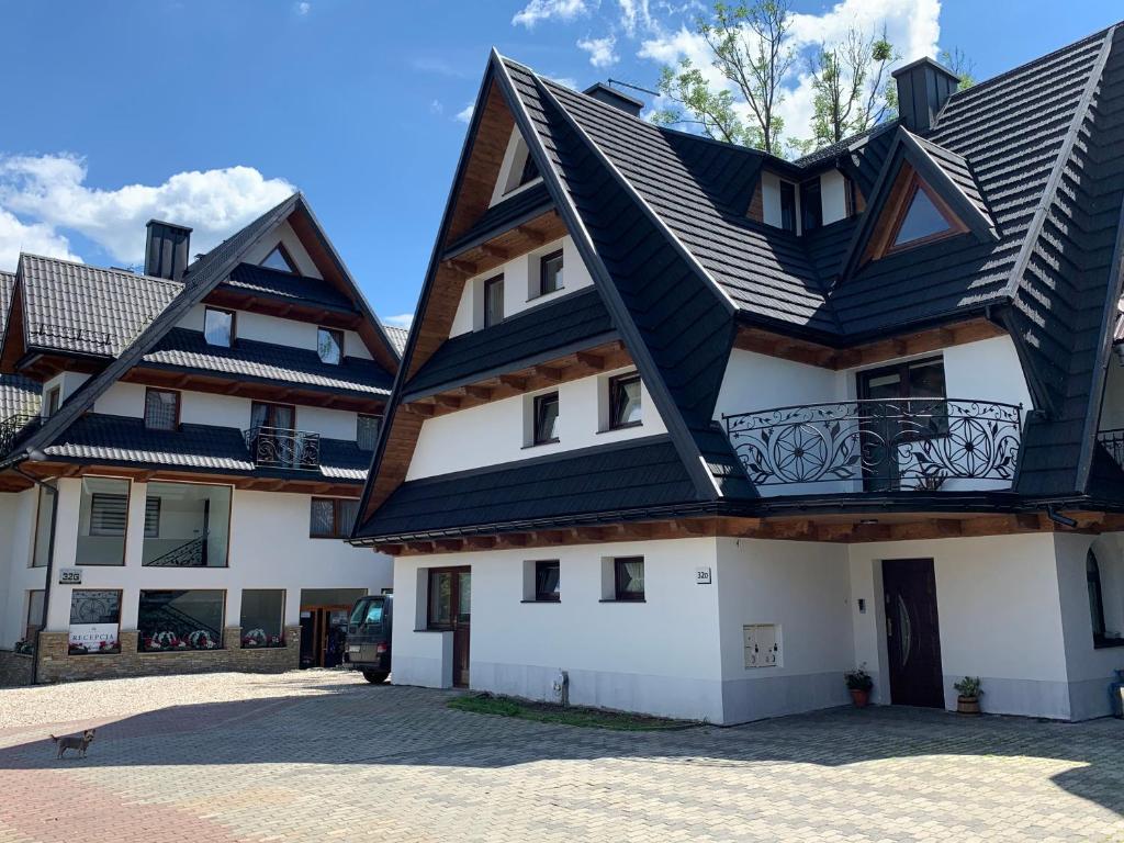 a house with a black roof at Gościniec Stachoń in Zakopane