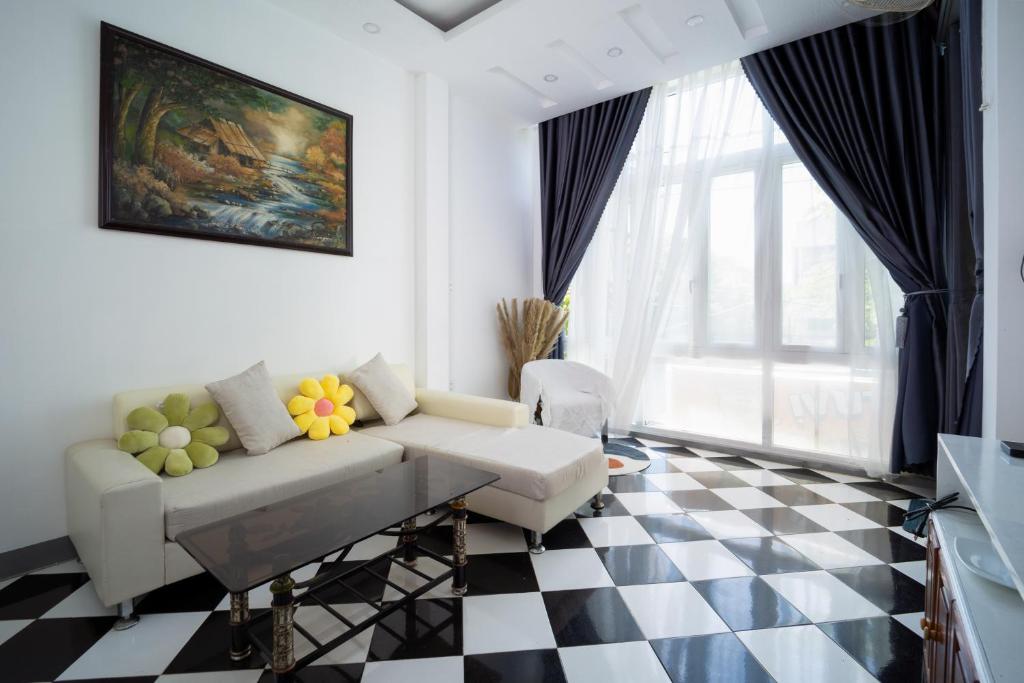 a living room with a couch and a checkered floor at Nhà đầy nắng homestay in Nha Trang