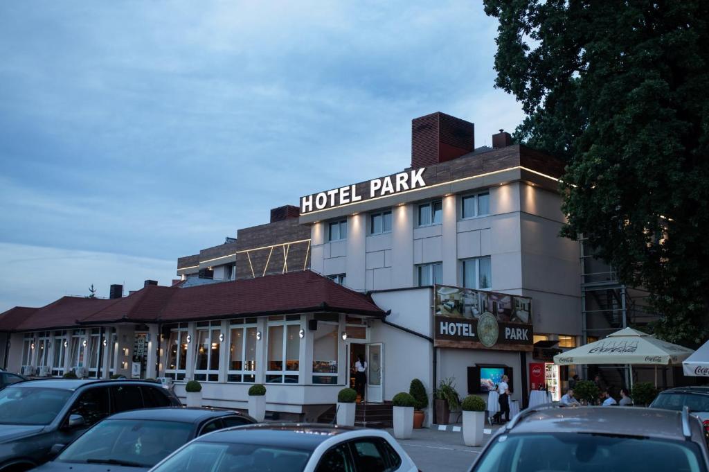 a hotel park with cars parked in a parking lot at Hotel Park in Srebrenik