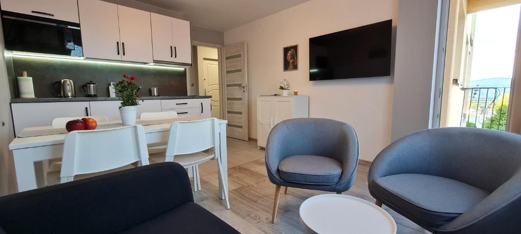 a living room with two chairs and a table at Apartament Panorama 6 20 in Polańczyk