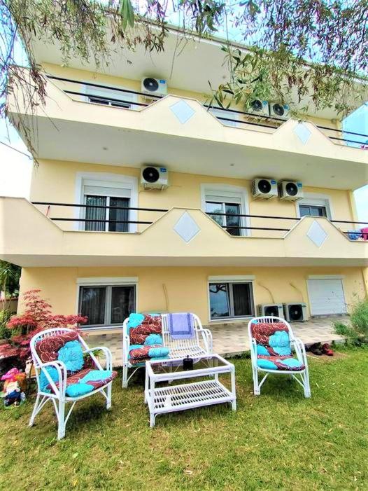 a group of chairs sitting in front of a building at Tsafas Αpartments in Limenas