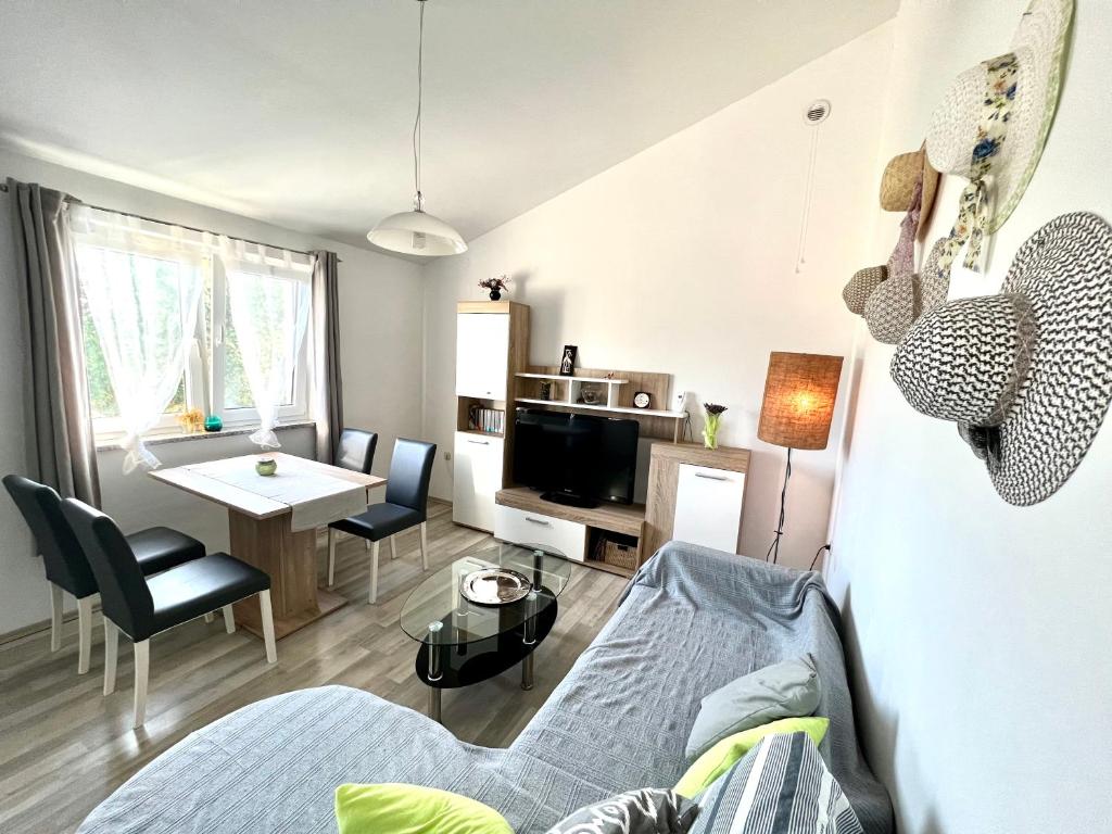 a living room with a bed and a dining room at Barbariga apartments in Vodnjan