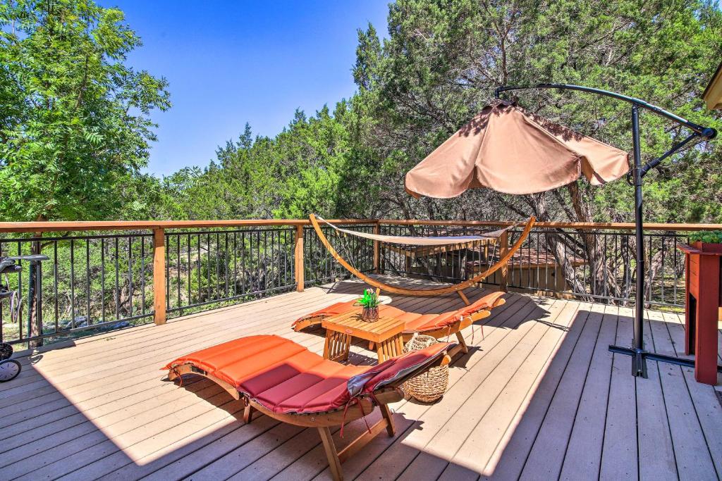 a deck with a hammock and a table and chairs at Updated Retreat with Game Room and Boat Ramp Access! in Lago Vista