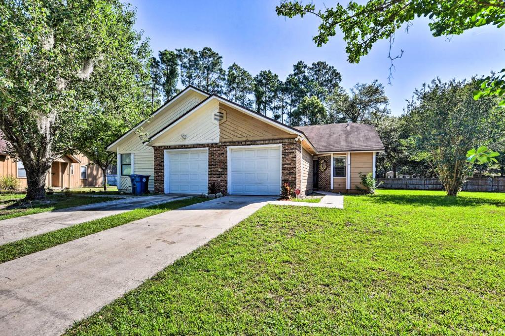 a house with a garage in a yard at Jacksonville Home about 10 Mi to Downtown! in Jacksonville
