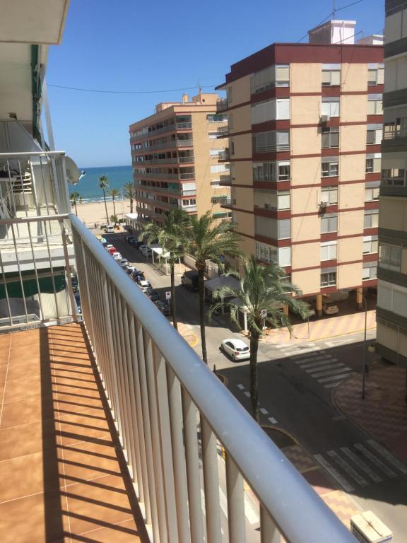 einen Balkon mit Blick auf den Strand und die Gebäude in der Unterkunft Apartamento Cullera-playa Parking Wifi in Cullera