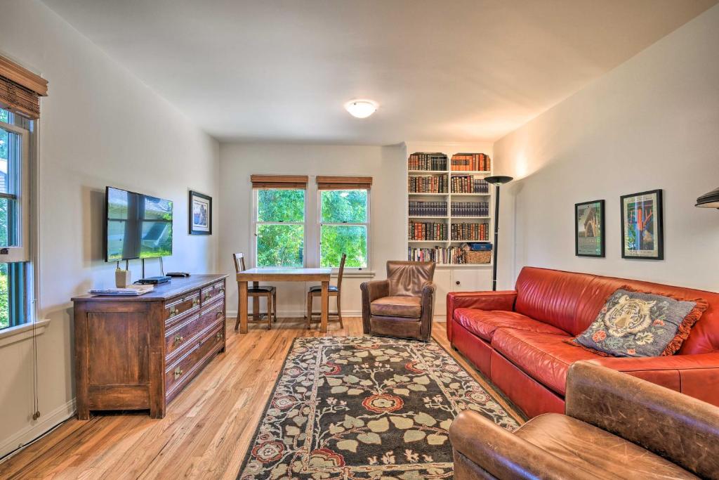 a living room with a red couch and a table at Central South Pasadena Apt, 3 Mi to Rose Bowl in South Pasadena