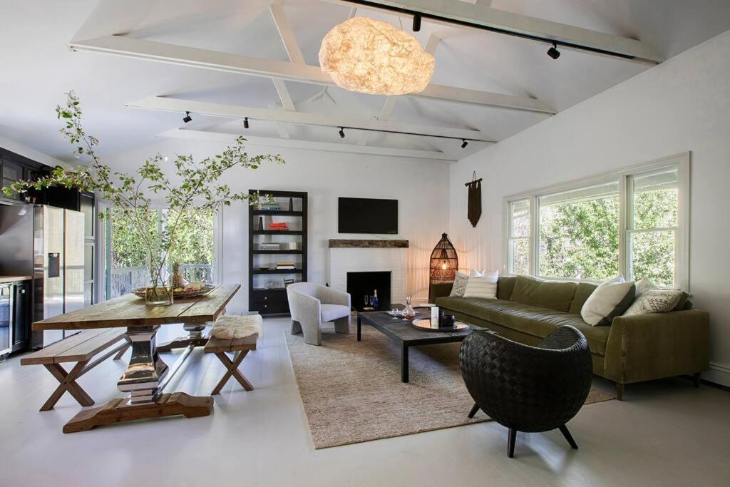 a living room with a couch and a table at Artist's Retreat In The Woods Five Acre Backyard in Roxbury