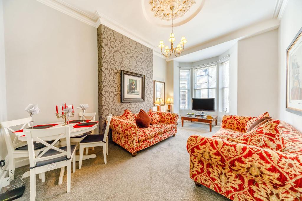 a living room with a table and a dining room at The Retreat in Wigton