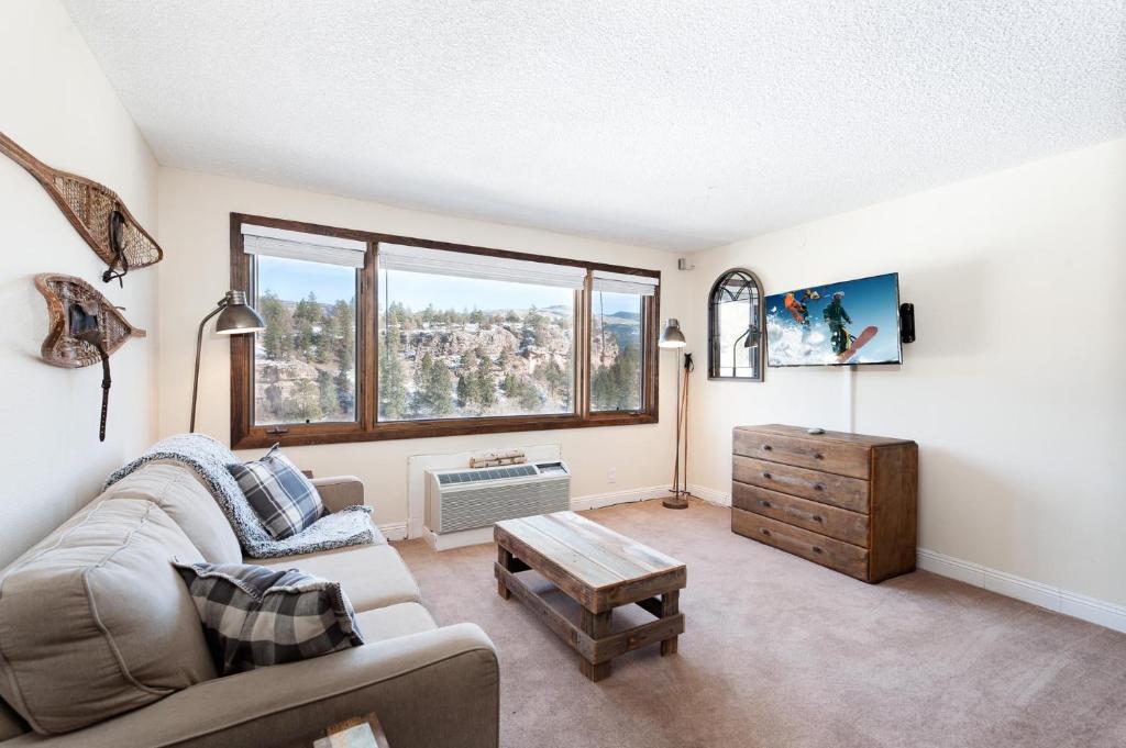 a living room with a couch and a table at Tamarron Lodge Studio 412 in Durango