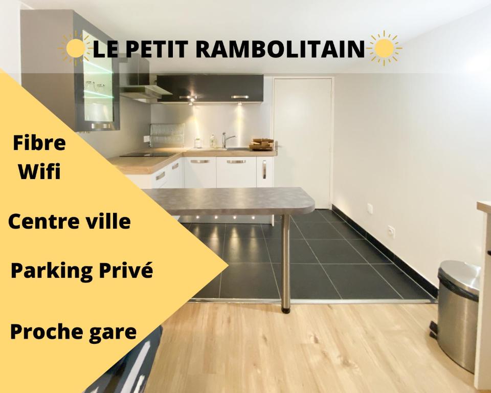 a kitchen with a table in a room at LE PETIT RAMBOLITAIN in Rambouillet