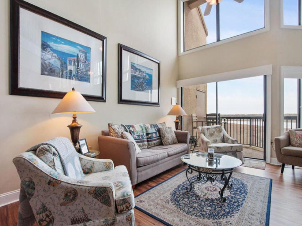 a living room with a couch and a table at 226 Captain's Quarters in Hilton Head Island
