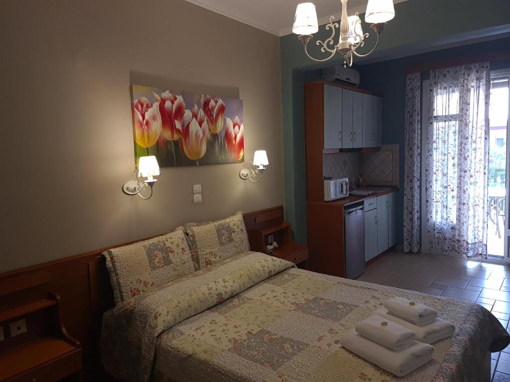 a bedroom with a bed with two towels on it at Edem Studios in Syvota