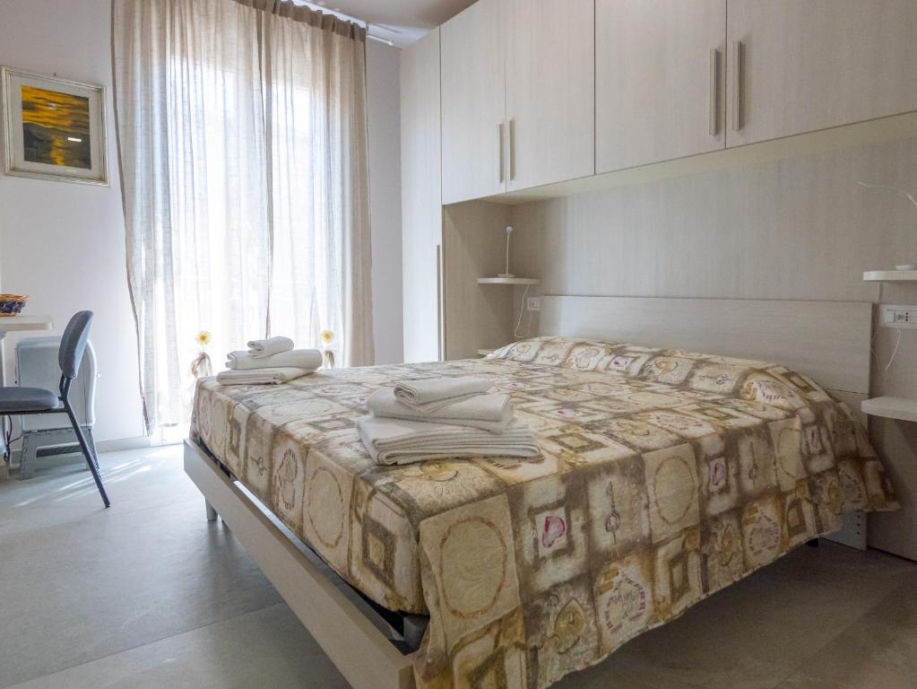 Säng eller sängar i ett rum på Camere Casa Azzurra
