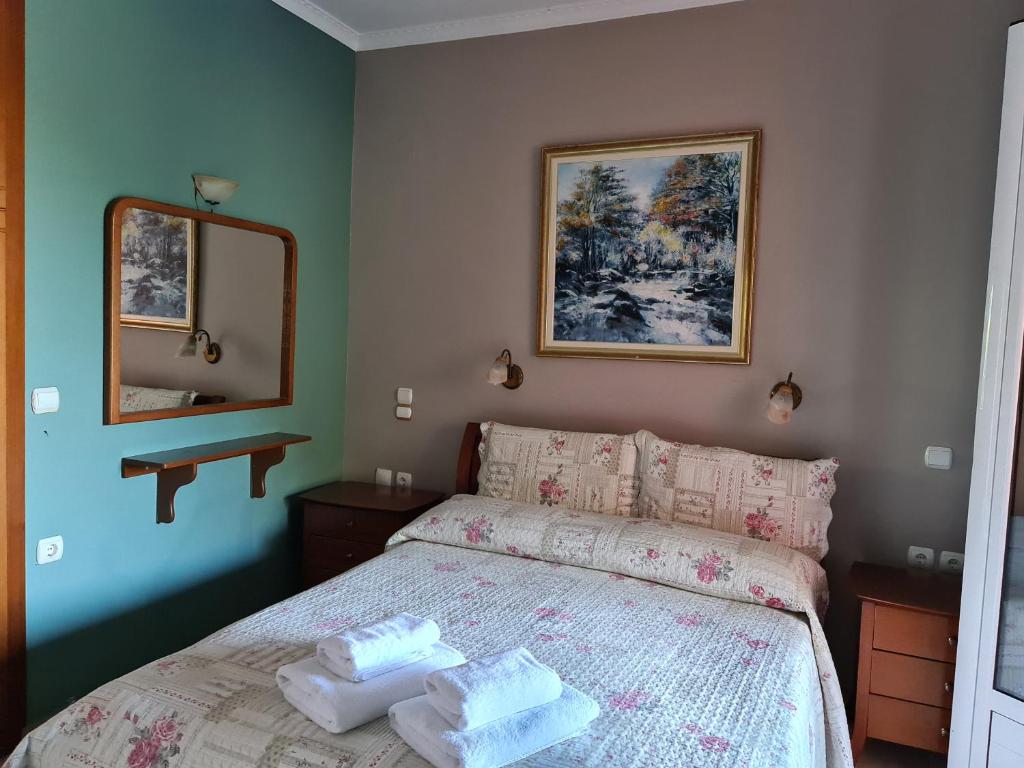 a bedroom with a bed with two towels on it at Edem Studios in Syvota