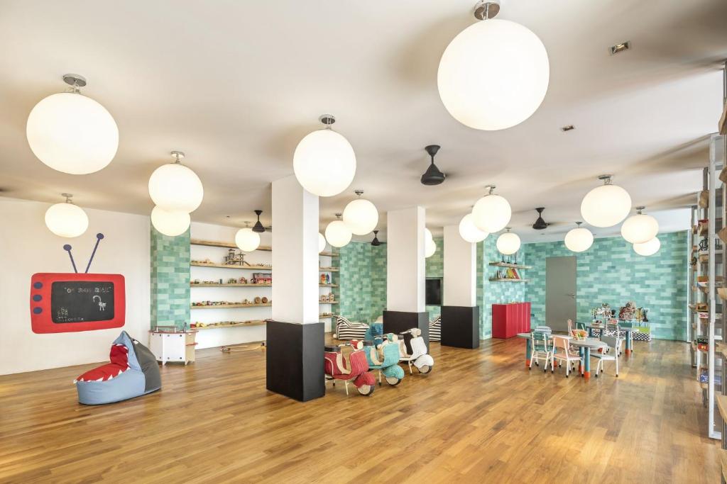 a childrens play area with lights and tables and chairs at COMO Uma Canggu in Canggu
