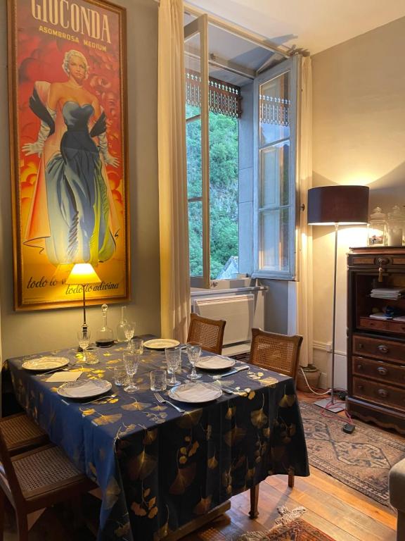 a dining room with a table with wine glasses on it at La Maison in Saint-Béat