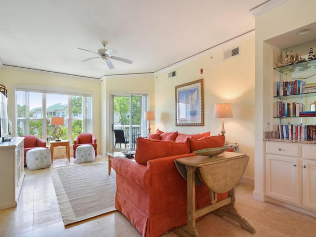 a living room with a red couch and a table at 6405 Hampton Place in Hilton Head Island
