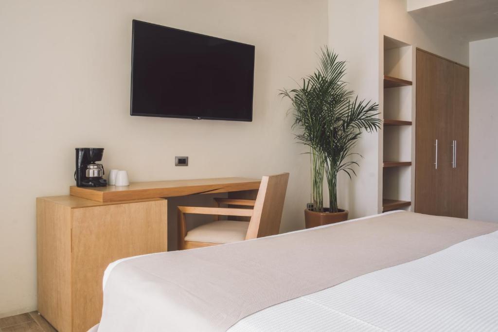 Postel nebo postele na pokoji v ubytování Hotel NYX Cancun