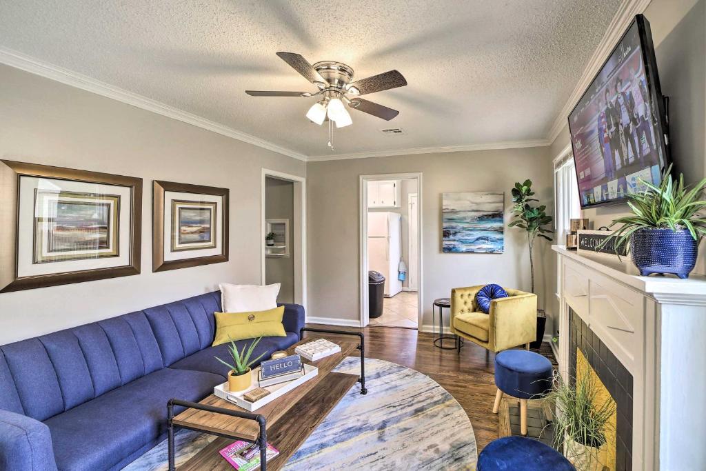 a living room with a blue couch and a tv at Adorable Tulsa Home Less Than 2 Mi to Expo Center! in Tulsa