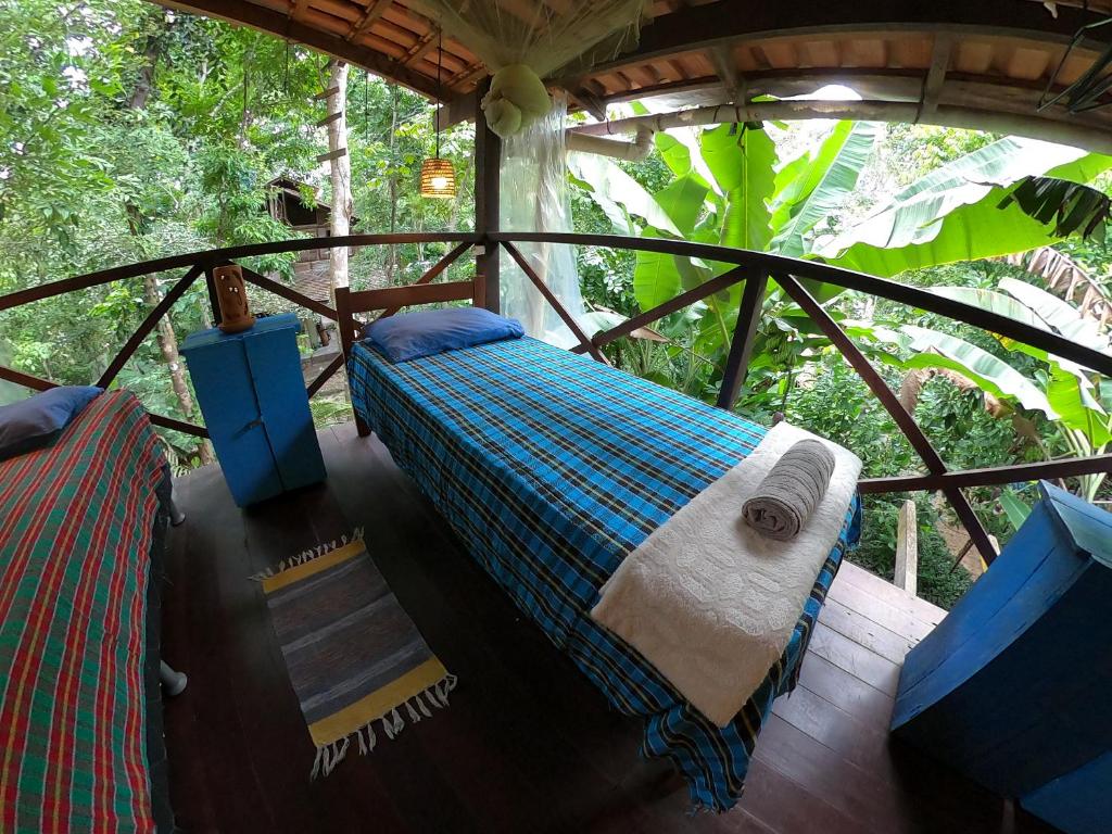 a bedroom with a bed in a tree house at Vila AMZ, Hostel Experiências in Alter do Chao