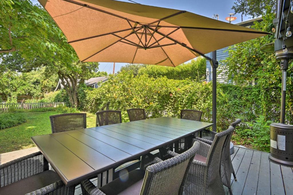 a table and chairs with an umbrella on a deck at Inviting Bungalow with Deck, Close to Dtwn LA! in South Pasadena