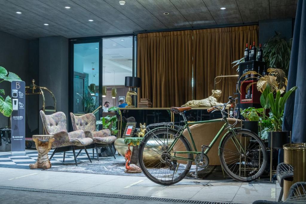 a bike is parked in a room with furniture at Hotel Eco Boutique Bidasoa in Santiago