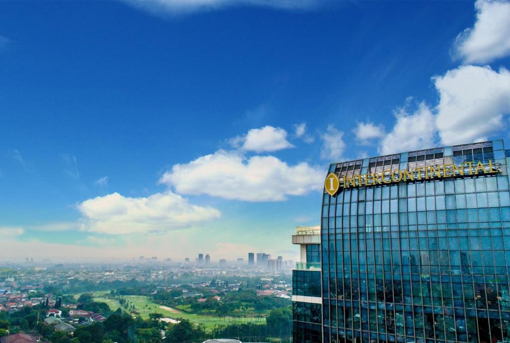 a large building with a sky background at InterContinental Hotels Jakarta Pondok Indah, an IHG Hotel in Jakarta