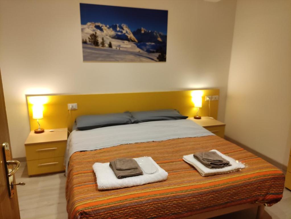 Postel nebo postele na pokoji v ubytování Doss della Pesa Apartment
