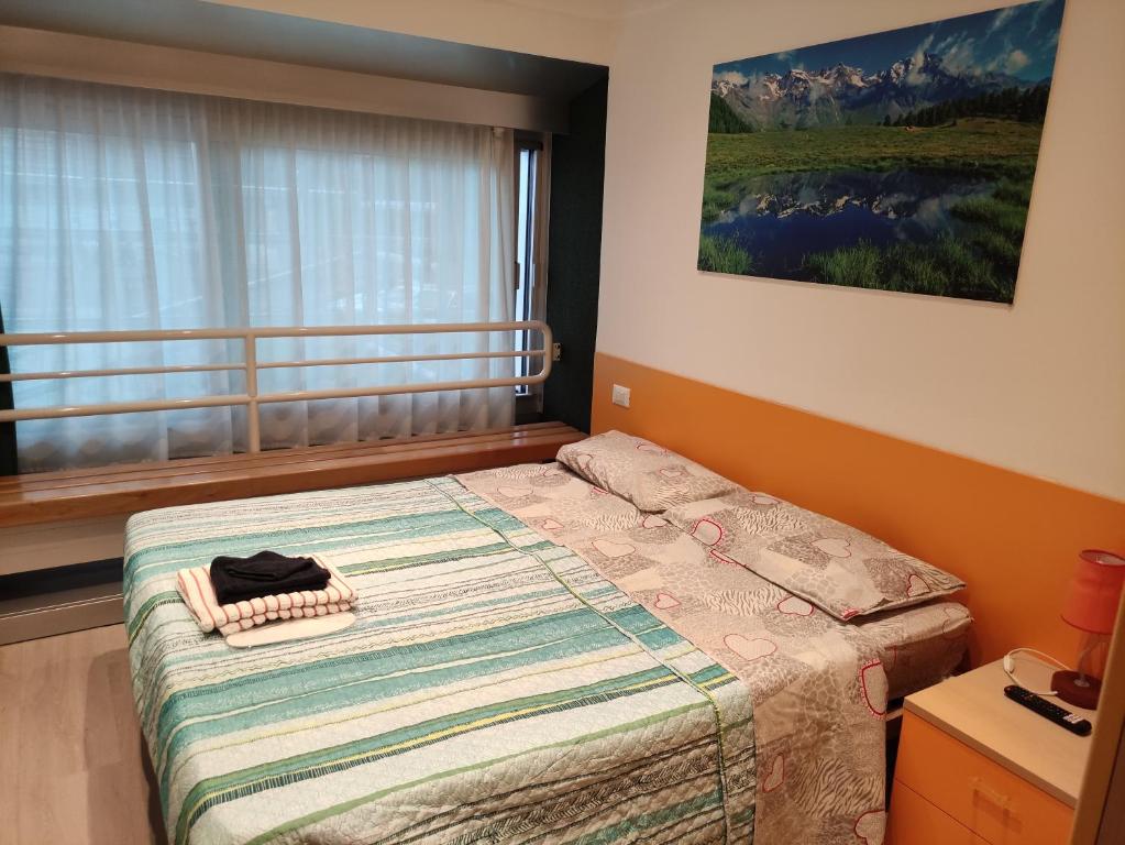 Postel nebo postele na pokoji v ubytování Doss della Pesa Apartment