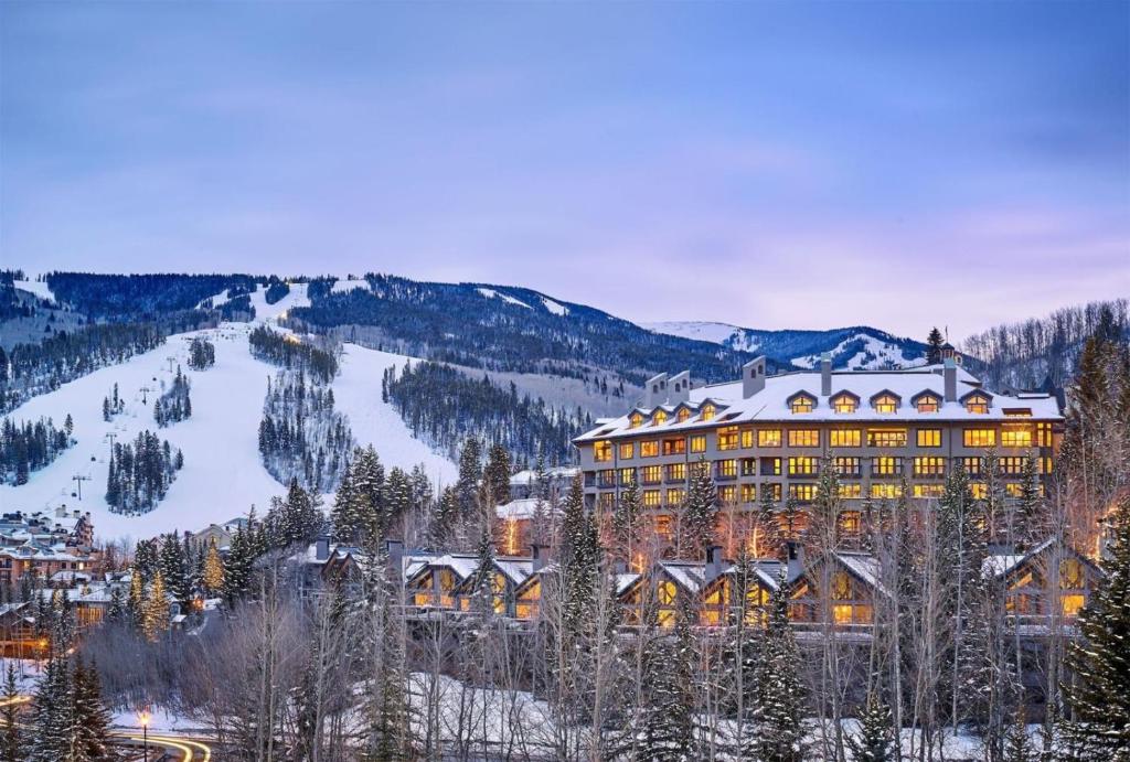 a large building in the mountains with snow on it at Beaver Creek Pines 3 Bedroom Ski In, Ski Out Vacation Rental With Restaurant, Outdoor Pool, Jacuzzi And Fitness Center in Beaver Creek