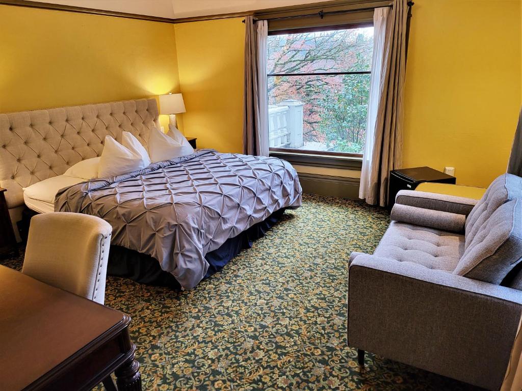 a hotel room with a bed and a window at Evermore Guesthouse in Portland