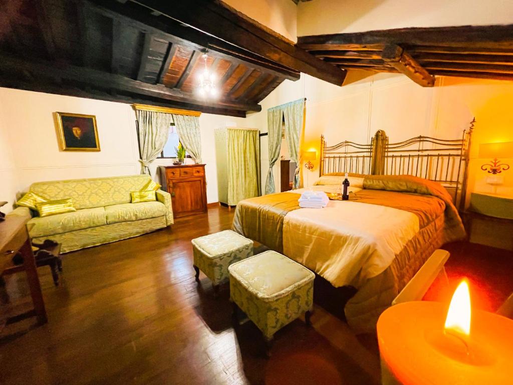 a bedroom with a large bed and a couch at Piazza Venezia Lulus Home in Rome
