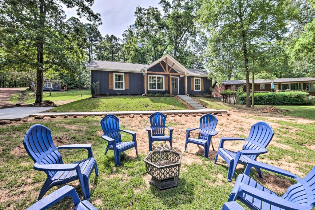 a group of blue chairs in front of a house at Stunning Avinger Retreat on Lake O the Pines in Avinger