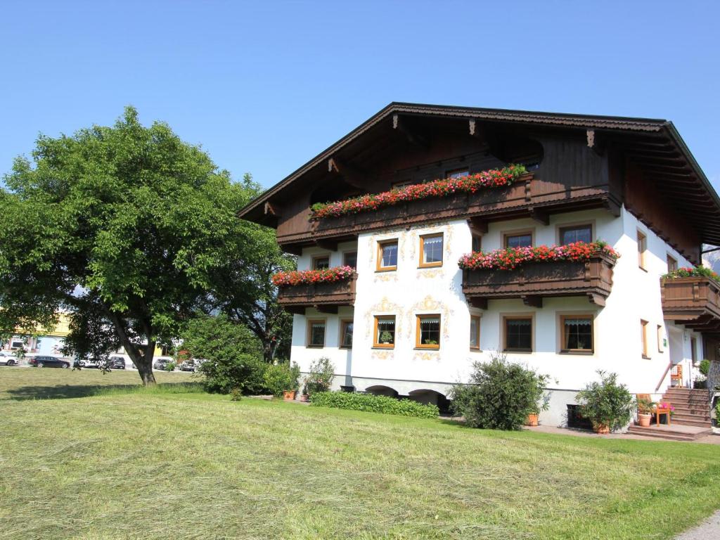 a large white building with flowers on it at Schleicherhof V in Strass im Zillertal