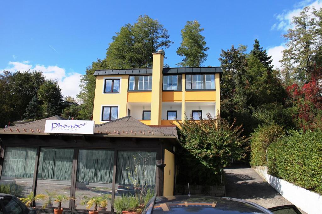 a yellow building with a sign in front of it at Pension Fürstenhof in Villach