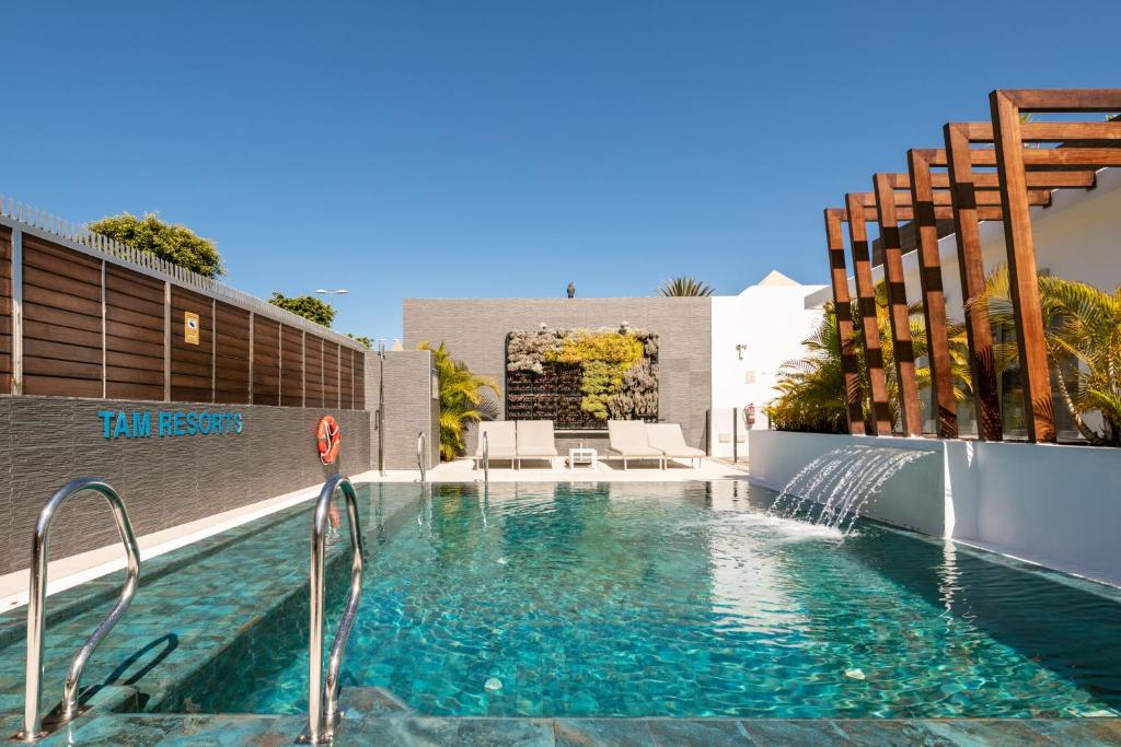 a swimming pool with a water feature in a house at Silvi Villas by TAM Resorts in Playa del Ingles