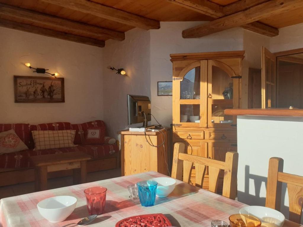 a kitchen and living room with a table and a couch at Appartement La Rosière, 3 pièces, 4 personnes - FR-1-275-131 in La Rosière