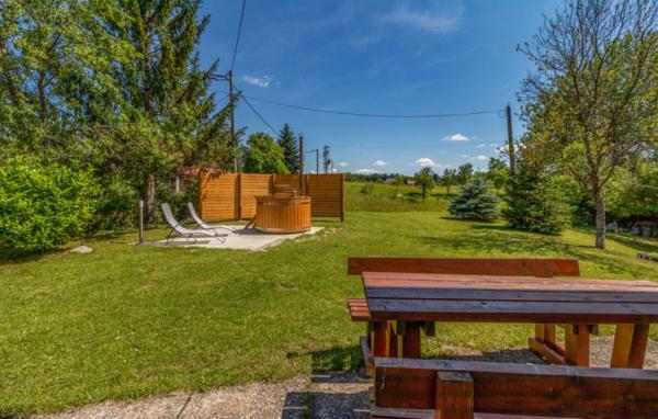 a park with a wooden bench and a playground at The House of Dunja in Rakovica