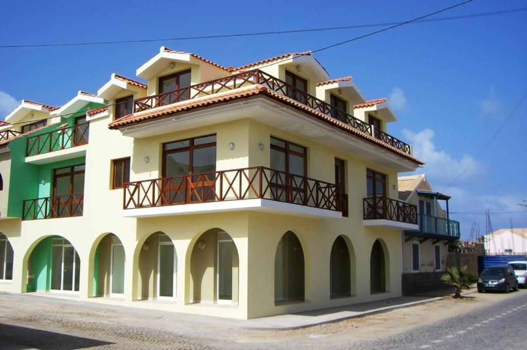 un edificio amarillo con balcón en la parte superior en One Bedroom Apartment Fogo Residence, en Santa Maria