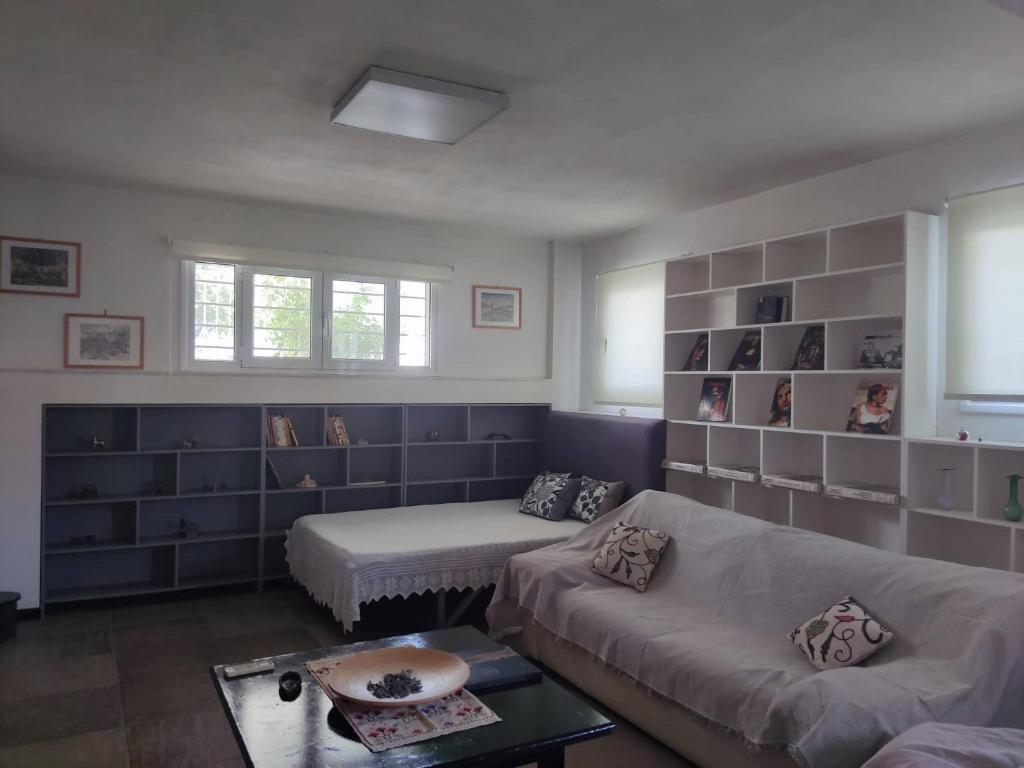 a living room with a couch and a table at Rodi House in Nafplio