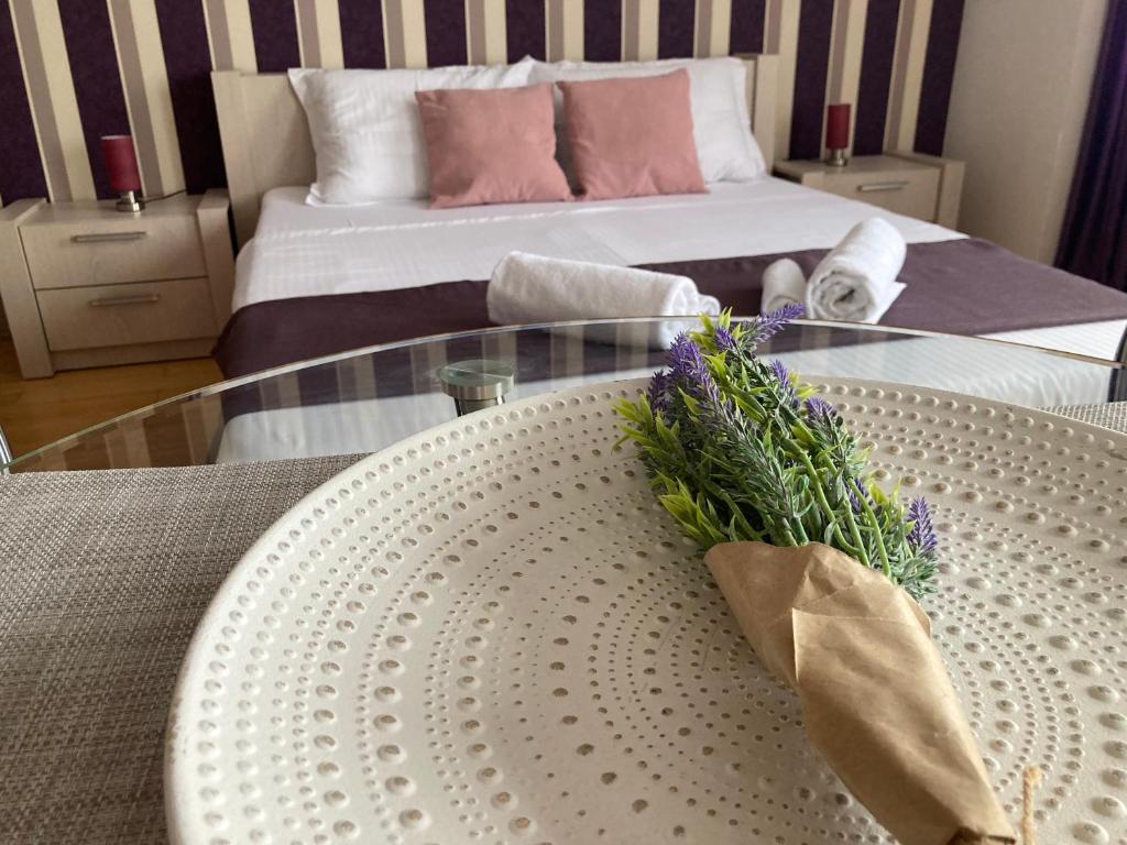 a room with a table with a bed in the background at Lira Beach Studio in Mamaia