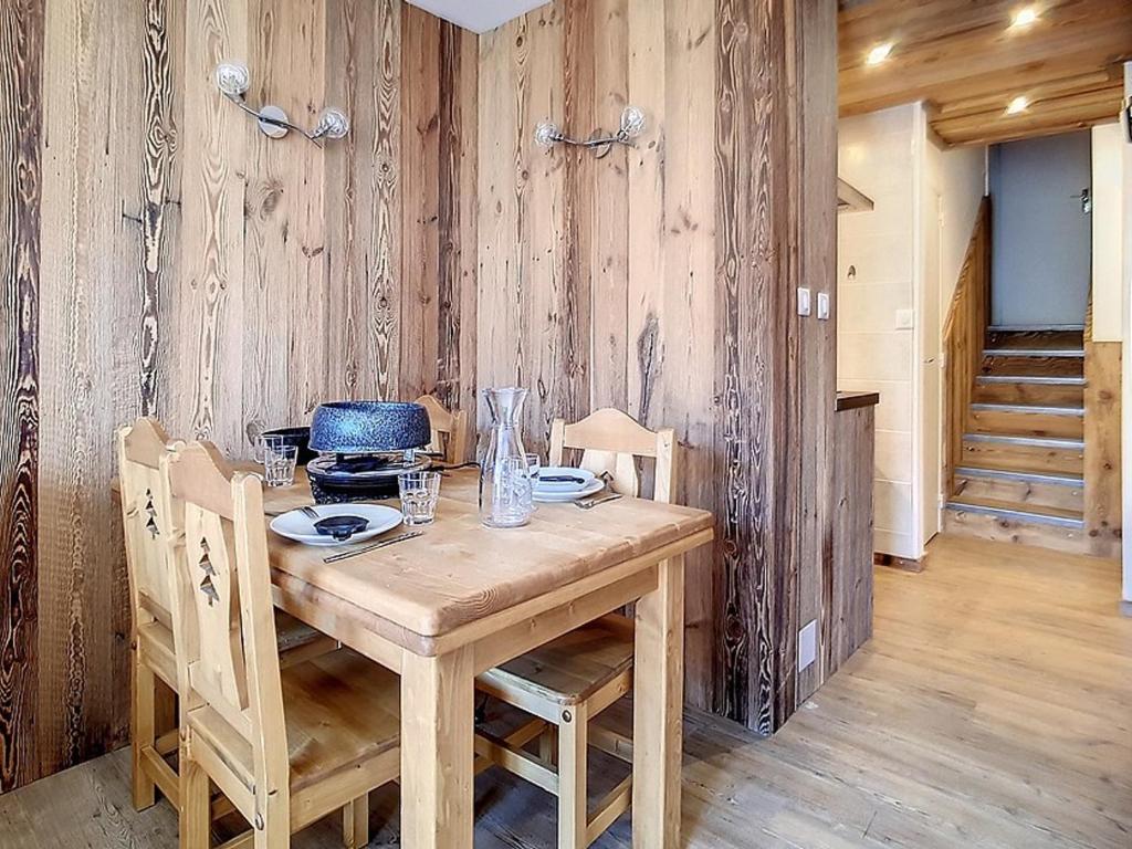 a wooden dining room with a wooden table and chairs at Appartement Les Menuires, 2 pièces, 5 personnes - FR-1-344-855 in Les Menuires