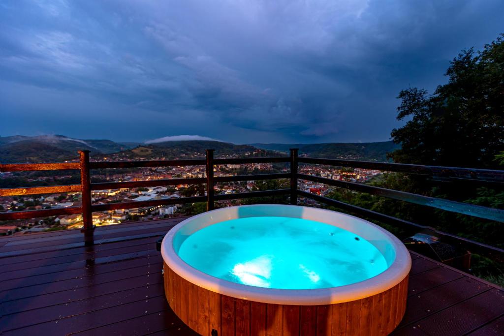 a jacuzzi tub on a deck with a view at Pension Bella Vista in Sighişoara