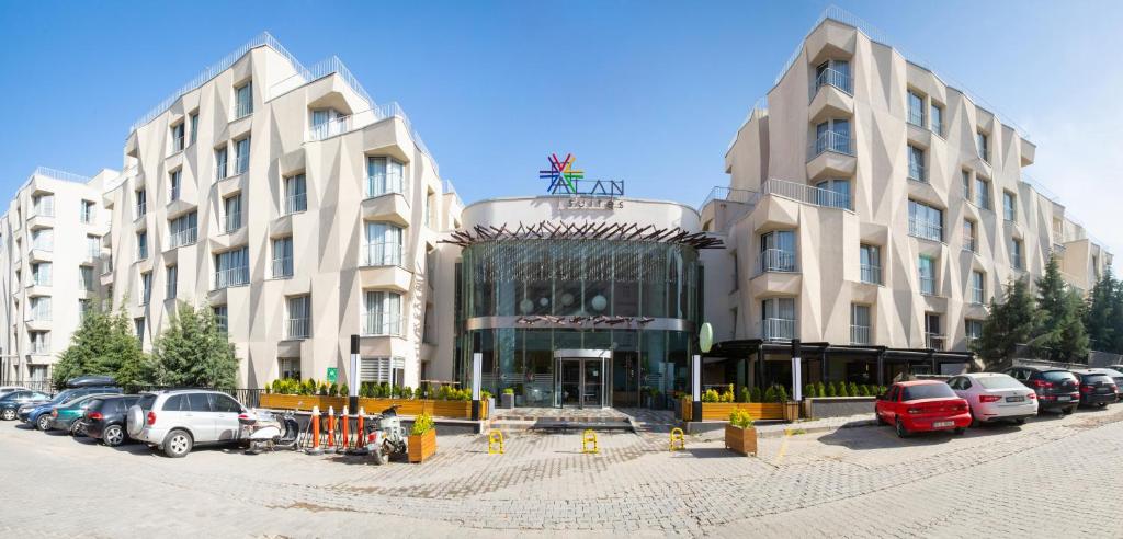 a large building with cars parked in front of it at Alan Suites in Edirne