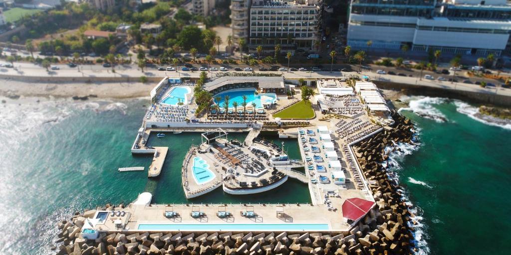 an aerial view of a marina with a cruise ship at Riviera Hotel and Beach Lounge, Beirut in Beirut