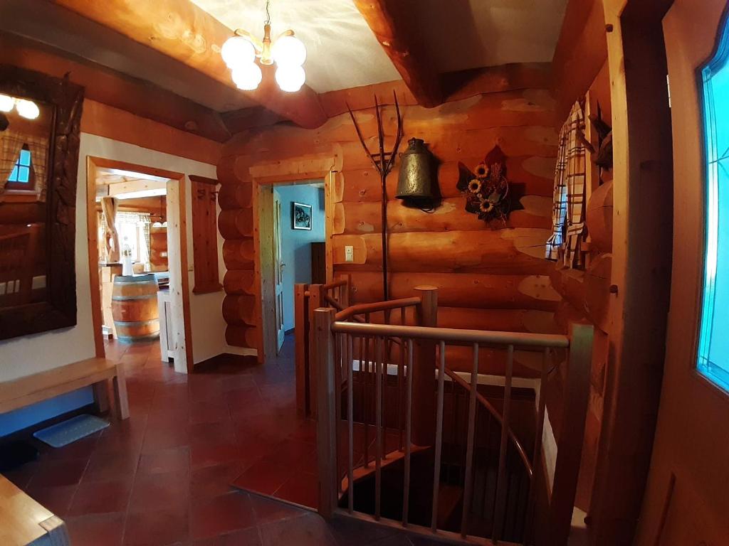 a hallway in a log cabin with a spiral staircase at Schönberghütte in Lachtal