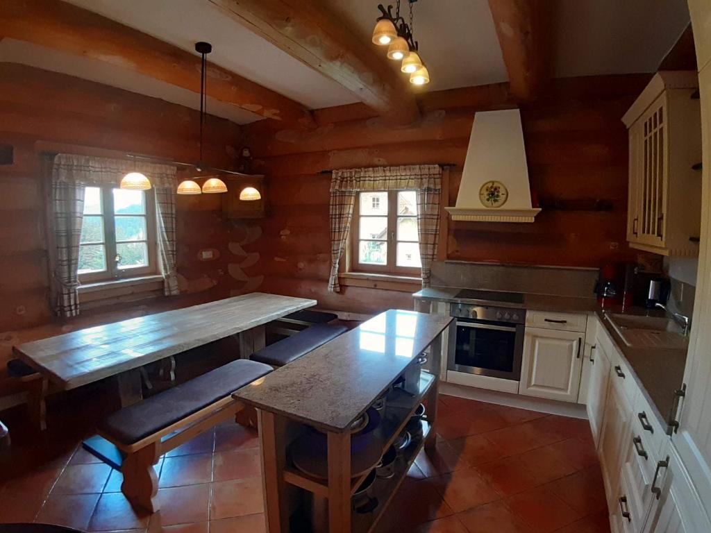 a kitchen with a large wooden table in a room at Schönberghütte in Lachtal