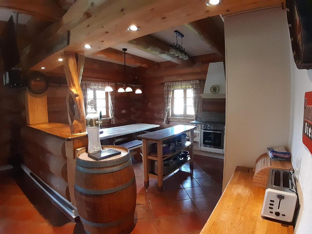 a kitchen with a table and a wine barrel at Schönberghütte in Lachtal